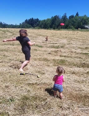 Image may contain: one or more people, people playing sports, people standing, child, grass, shorts, outdoor and nature